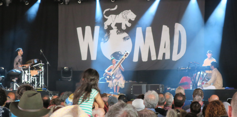 Anoushka Shankar with her daughter raised up in the crowd